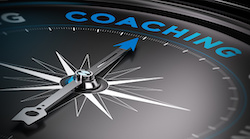 Attain personal goals, personal trainer concept. Conceptual Compass with needle pointing to the word coaching.